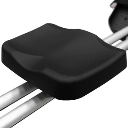 Black seat on rowing machine with a white background