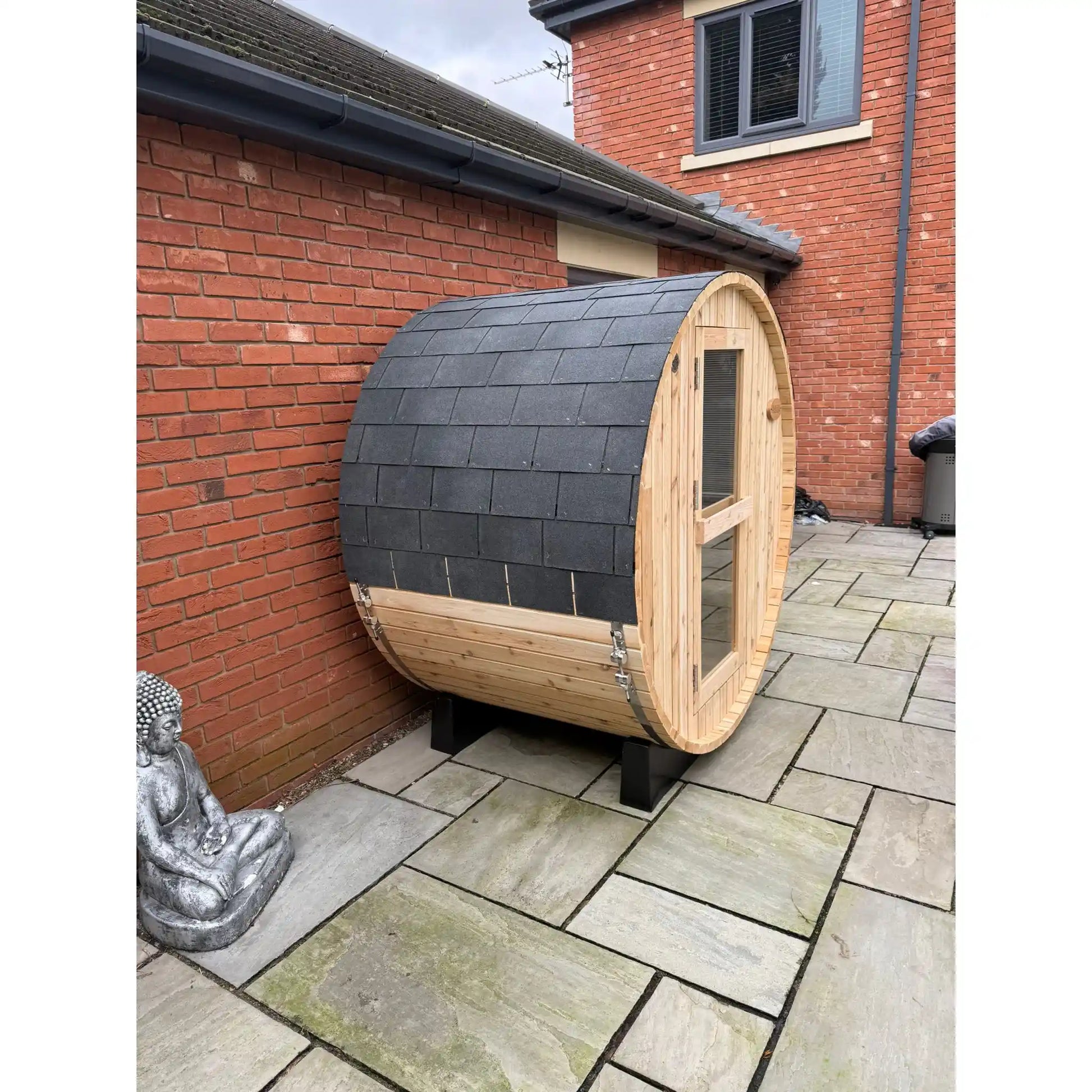 Wooden barrel sauna in garden setting