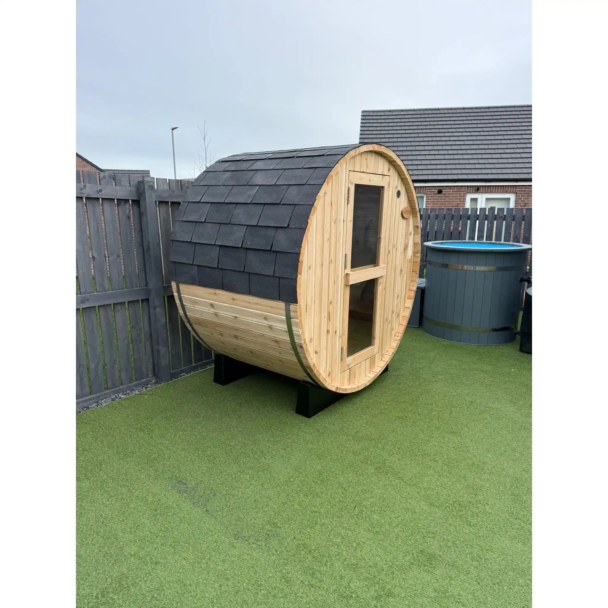 Wooden barrel sauna in garden setting