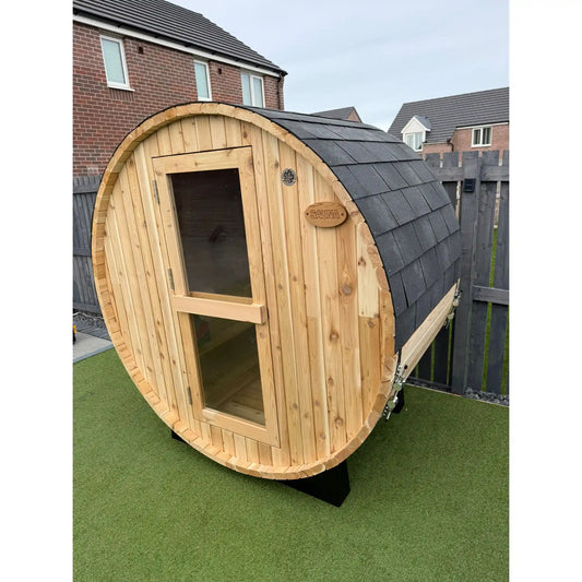 Wooden barrel sauna on in garden setting