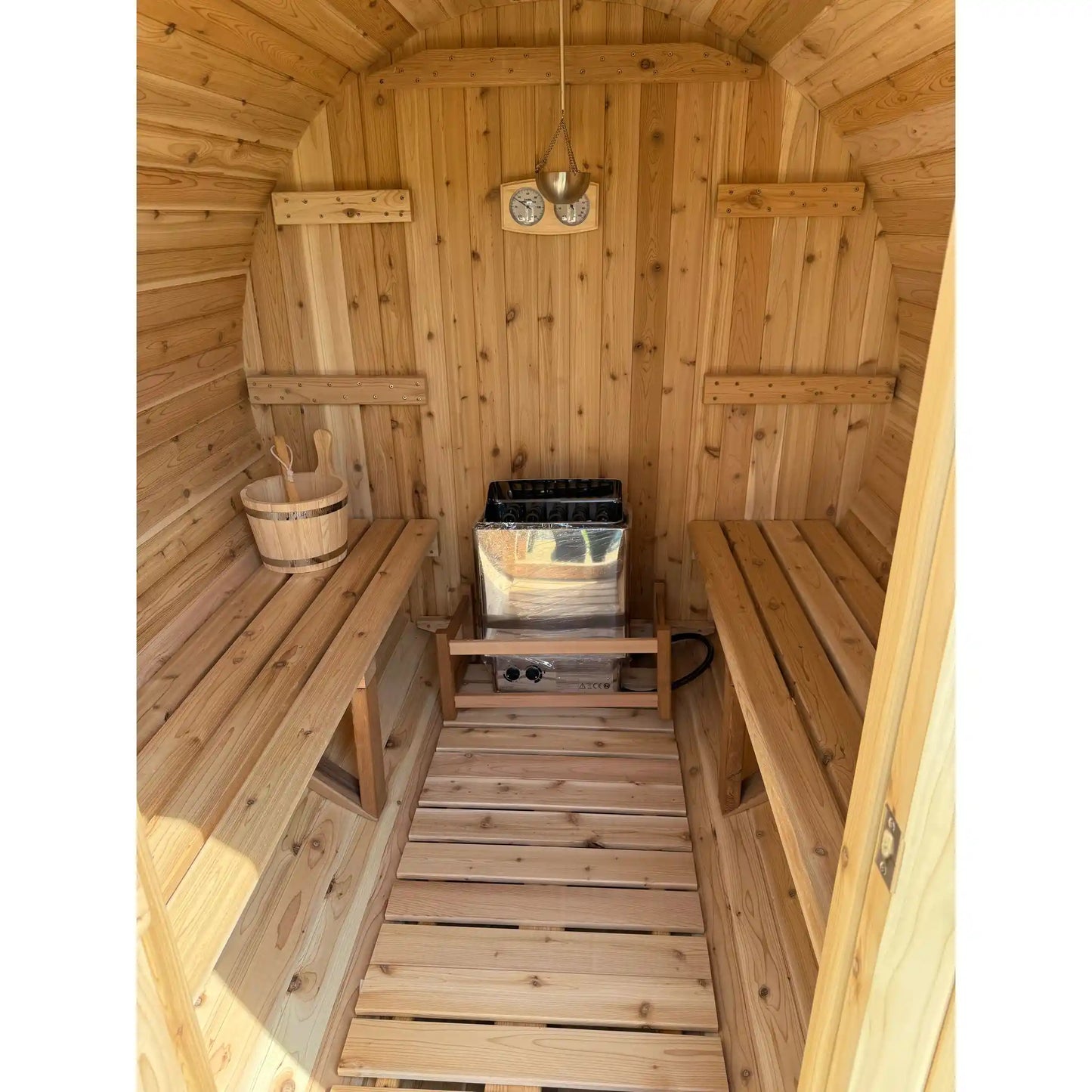 Wooden sauna with benches and a heater