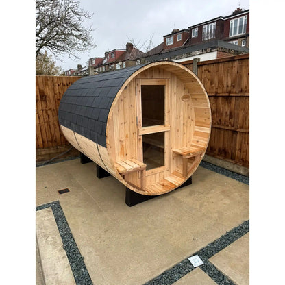 Wooden barrel sauna in a garden setting