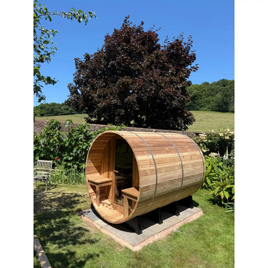 Wooden barrel sauna in a garden setting