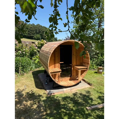 Wooden barrel sauna in a garden setting