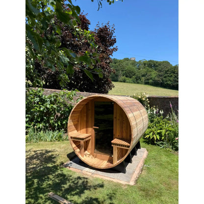 Wooden barrel sauna in a garden setting