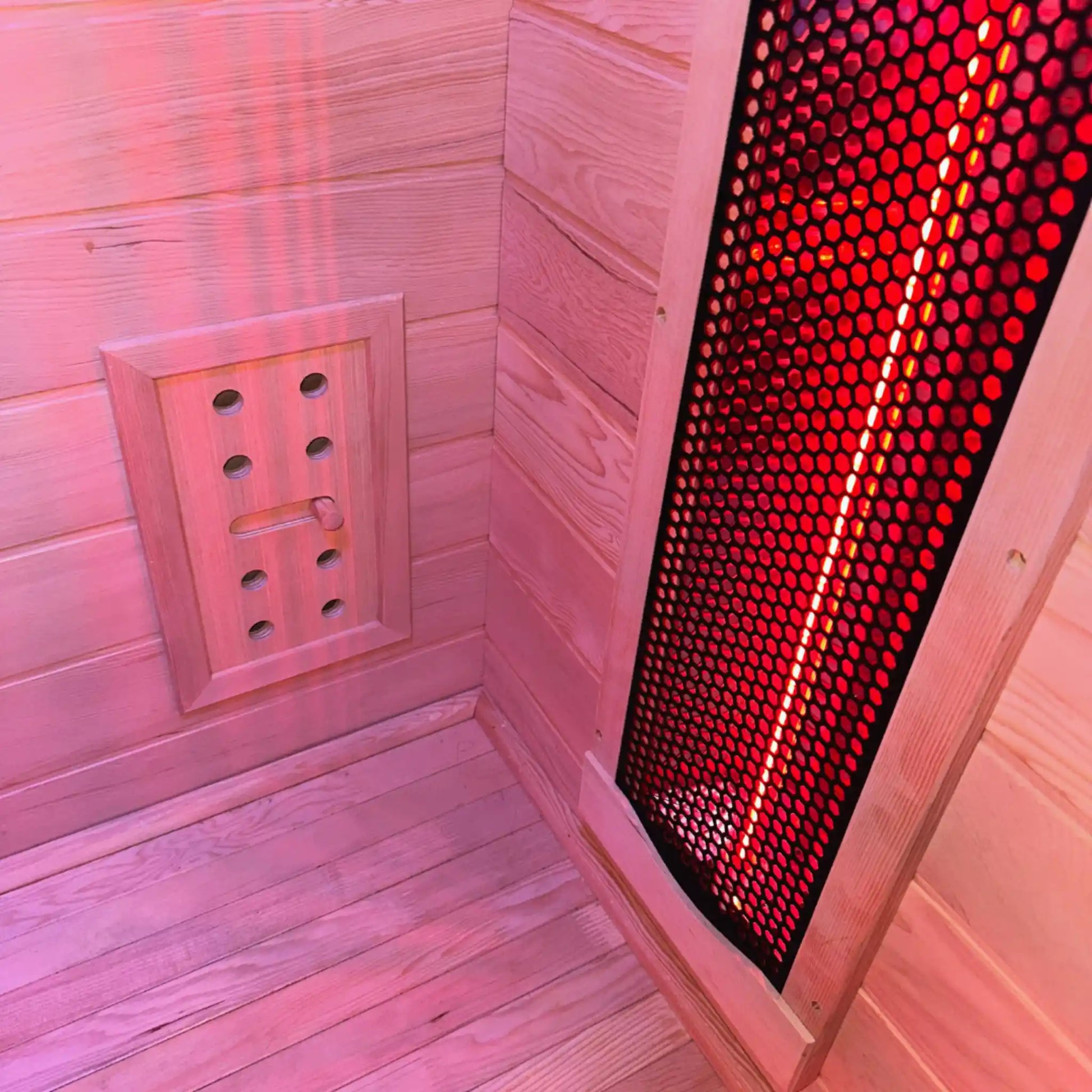 Wooden sauna with red light therapy panel