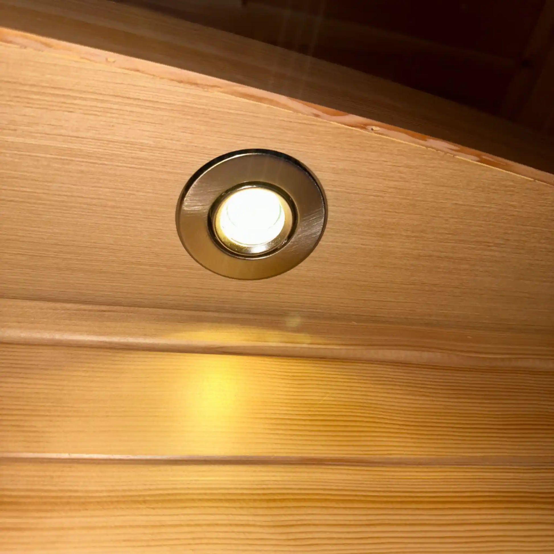 Wooden sauna ceiling with a recessed light fixture