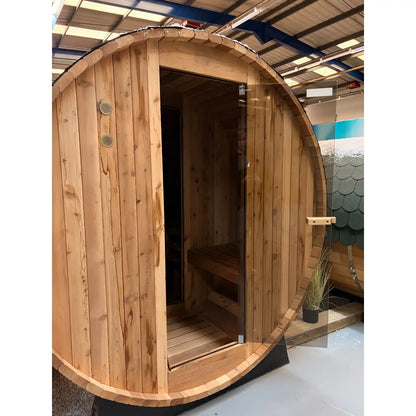 Wooden barrel-shaped sauna in a showroom setting