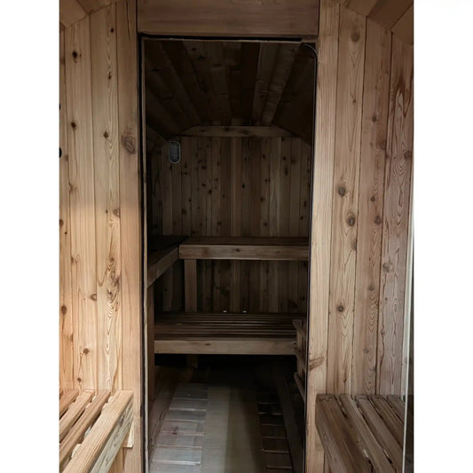 Wooden sauna with benches and a door open