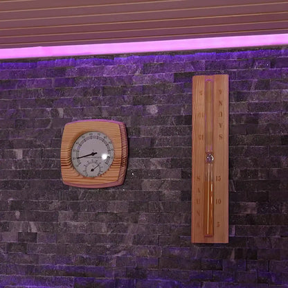 Wooden thermometer and hygrometer on stone wall inside a sauna