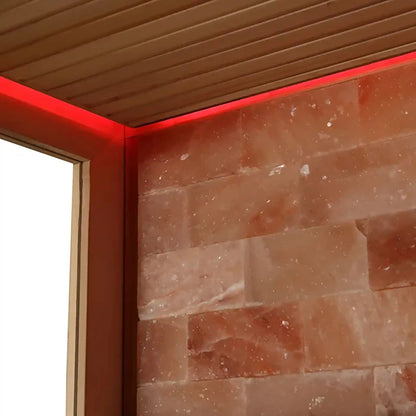 Sauna wall with wooden ceiling and red light around the edges