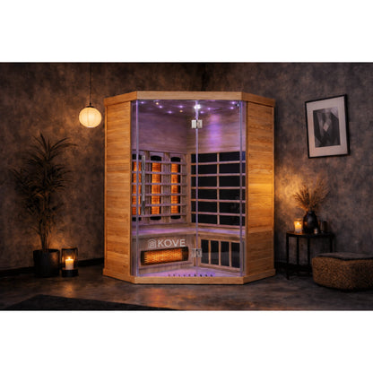Infrared sauna with KOVE branding in a dimly lit room.