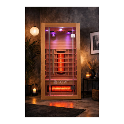 Infrared sauna with Kove branding in a dimly lit room.