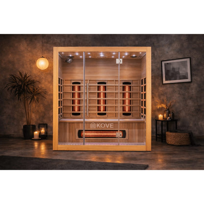 Infrared sauna with Kove branding in a dimly lit room.