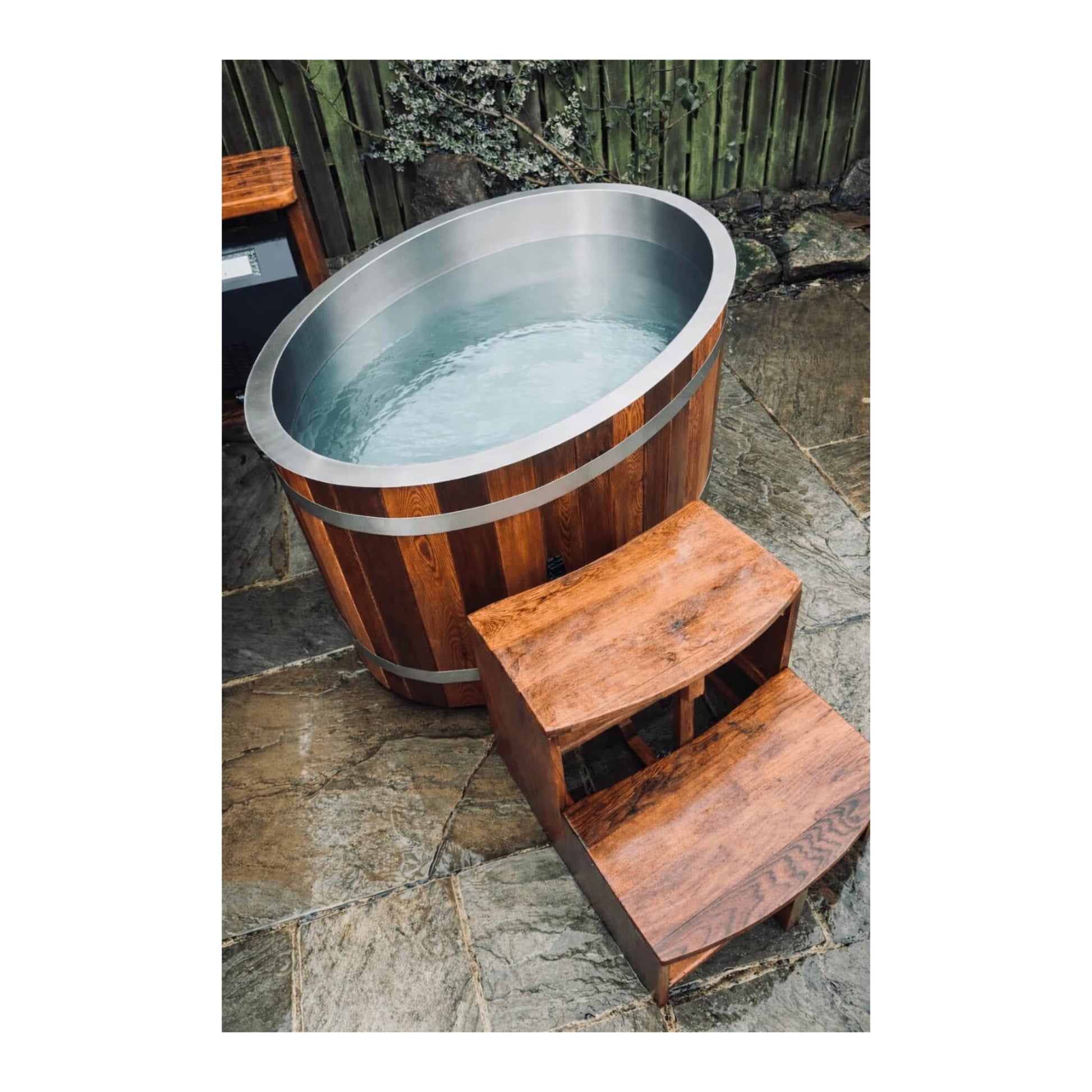Full KOVE Oval Ice Bath in a garden
