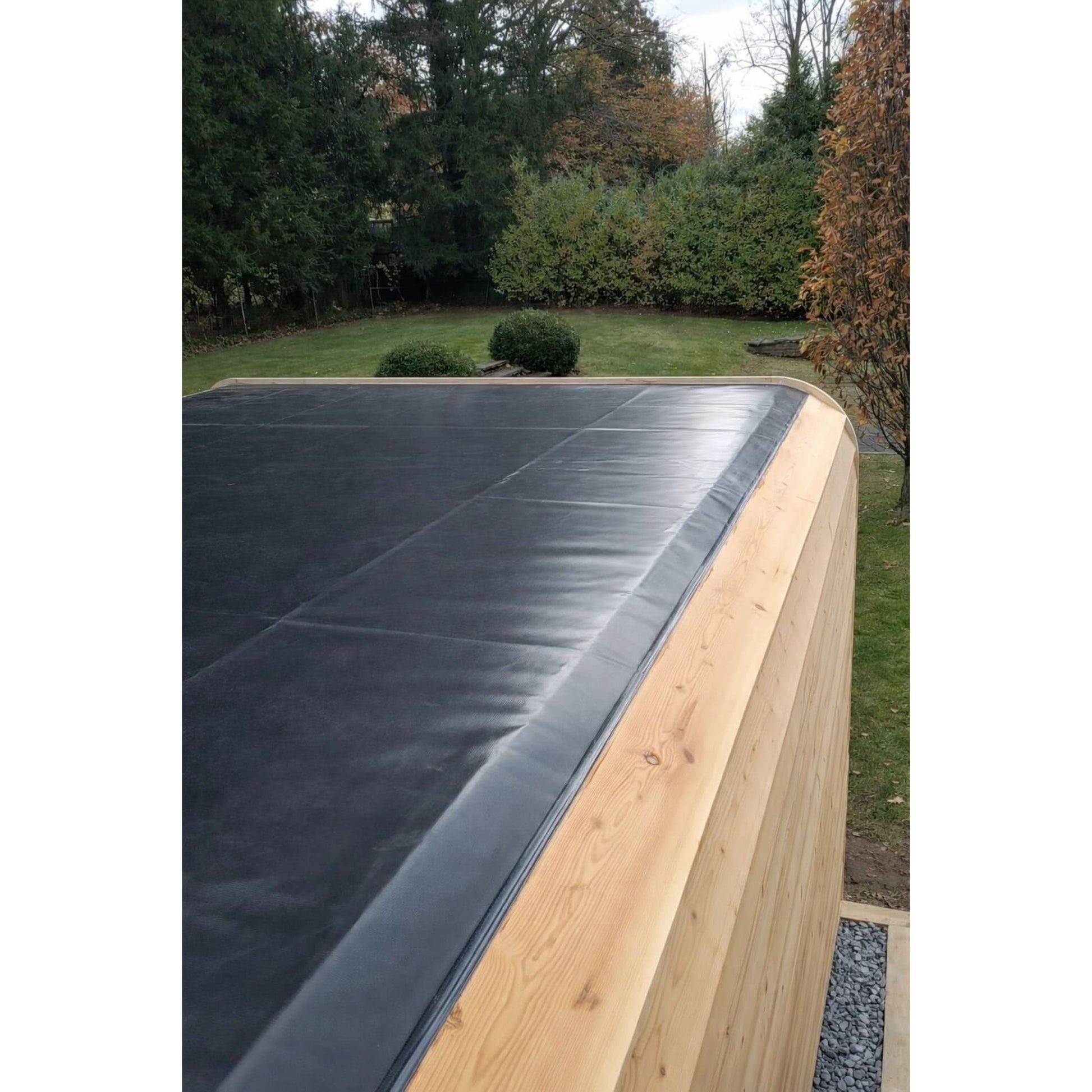 Roof of wooden sauna in a backyard setting