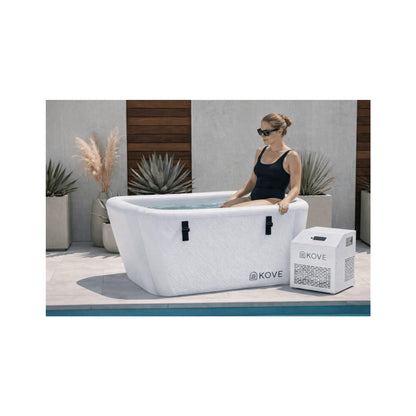 Lady getting into a white Kove Elite Ice Bath by a pool