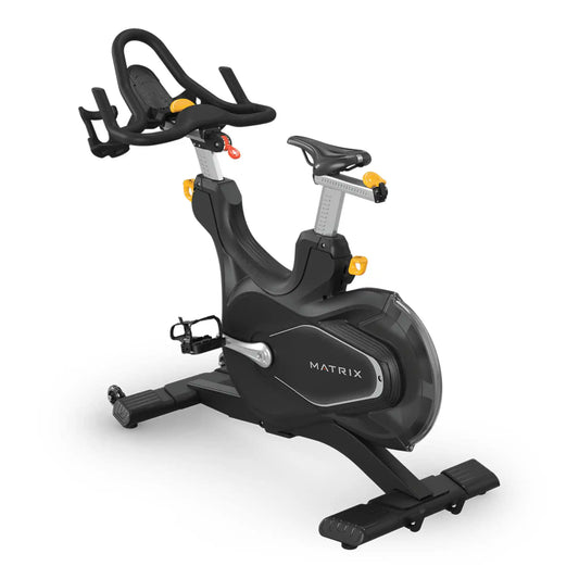 A black and silver MATRIX indoor cycling machine with yellow accents, shown from a three-quarter angle on a white background.