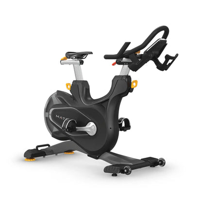 A black indoor cycling machine with silver handlebar stems and small orange accents, shown on a clean white background.
