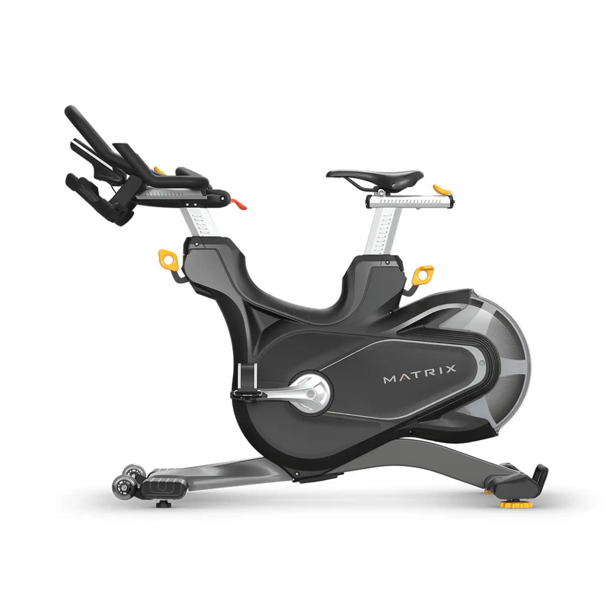 A Matrix brand indoor cycling machine in black with silver metallic accents and small yellow details, shown from a three-quarters angle on a white background.