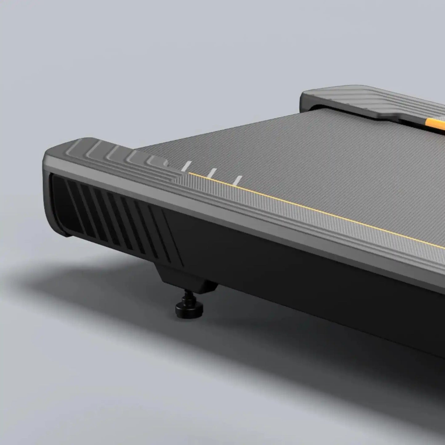 Close up of black treadmill running deck on a light grey background
