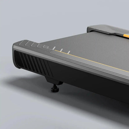 Close up of black treadmill running deck on a light grey background