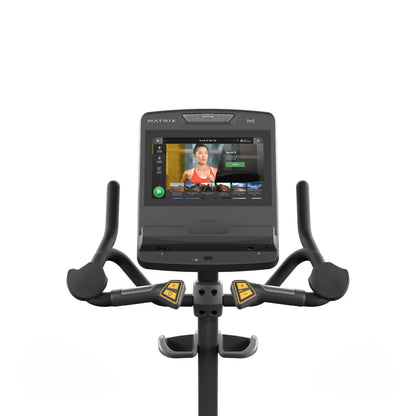 Exercise bike with a screen displaying a workout interface on a white background