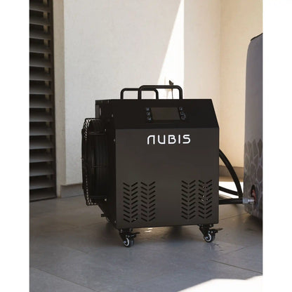 Black Nubis ice bath chiller on wheels on patio with light-colored walls in the background