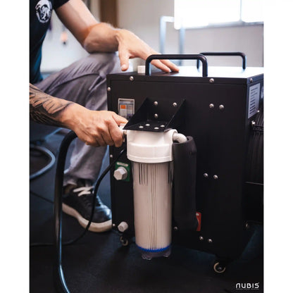 Person interacting with a black ice bath chiller with a filter, branded 'Nubis'.