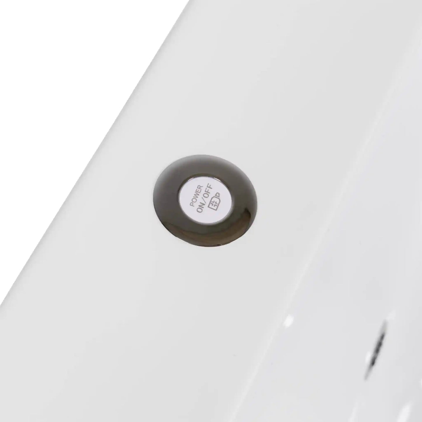 Close-up of a white power button for lighting on a white ice bath 