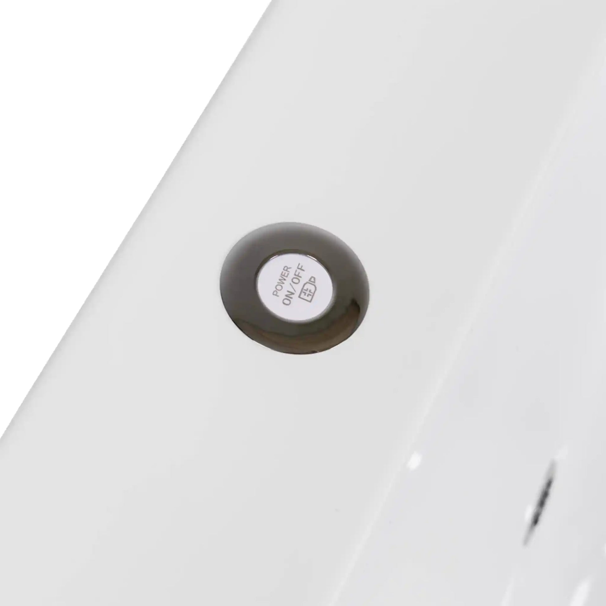 Close-up of a white power button for lighting on a white ice bath 