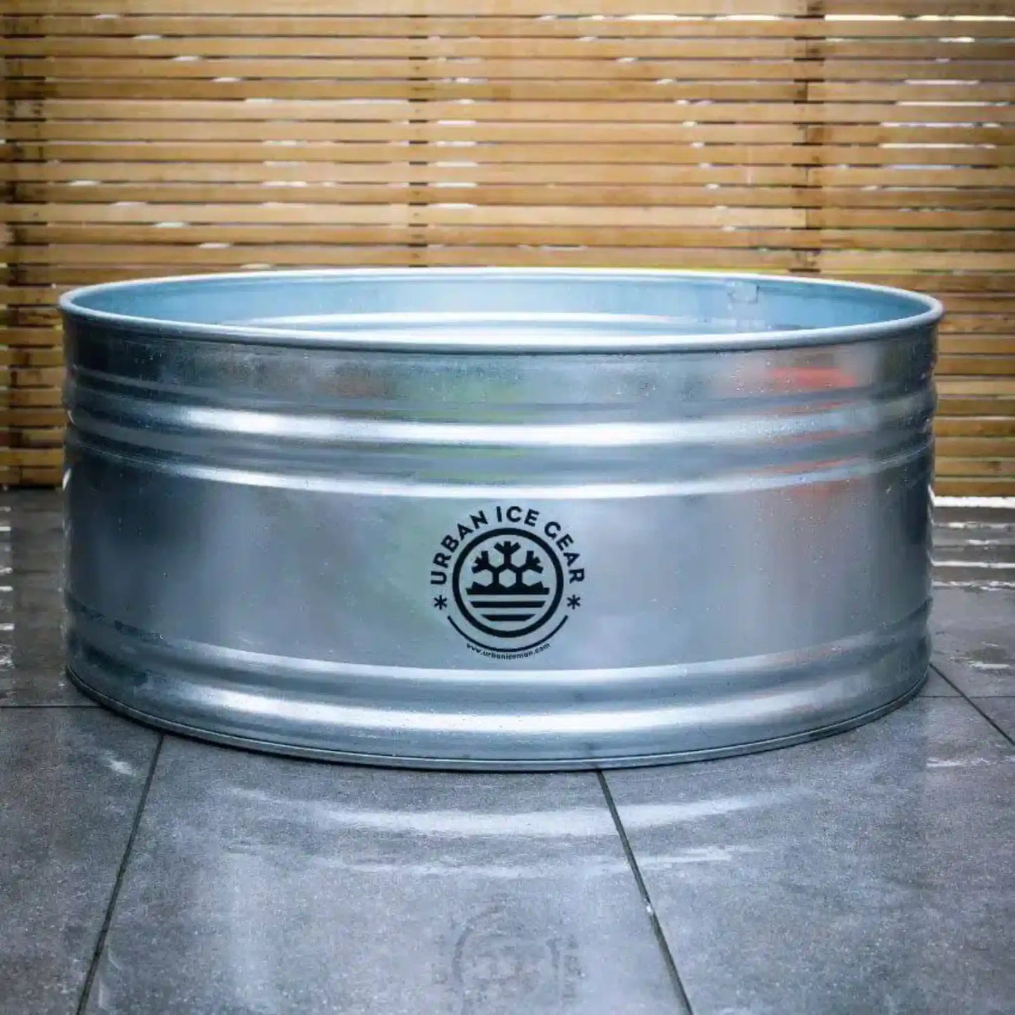 Metal ice bath with 'Urban Ice Tribe' logo in a garden setting