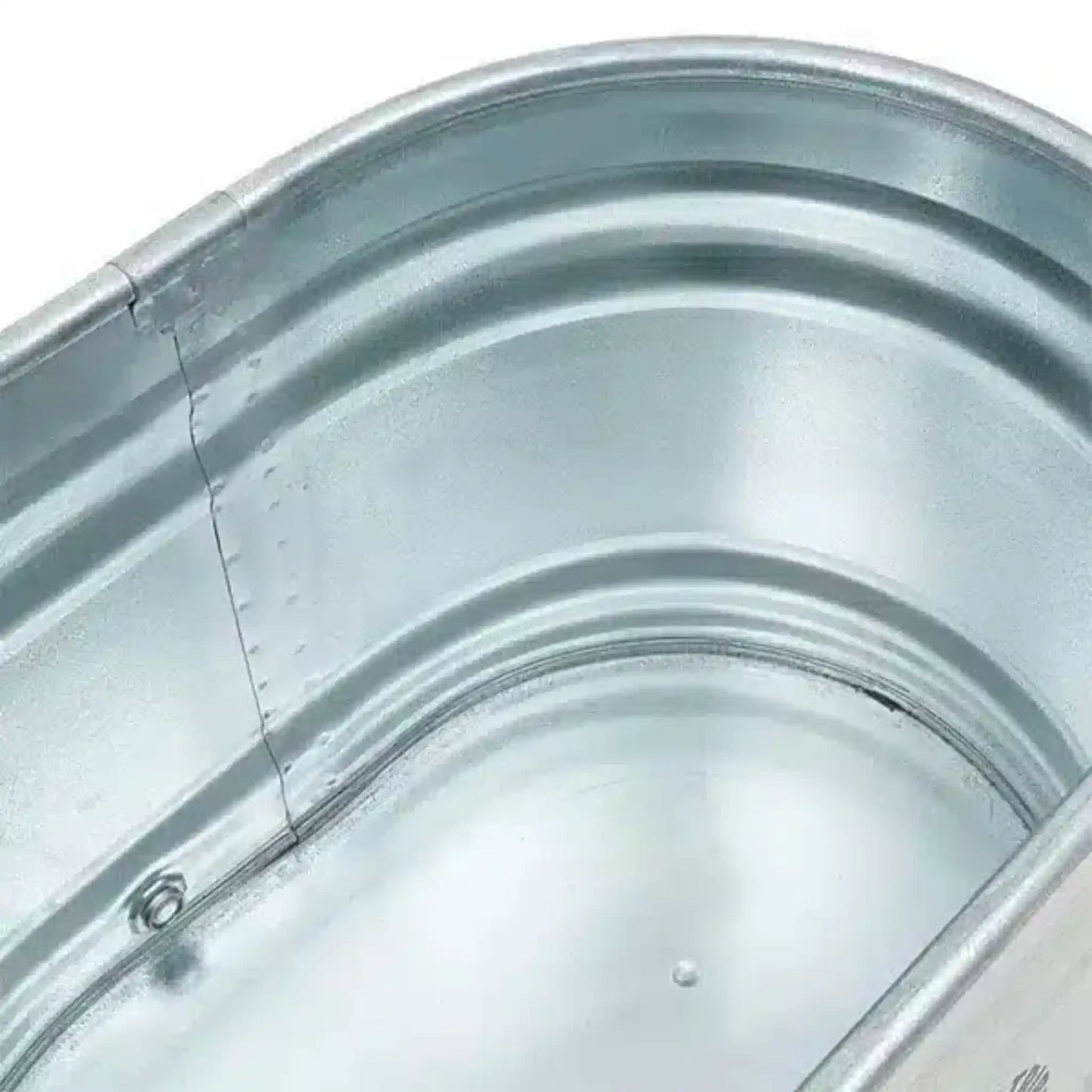 Inside of a steel ice bath on a white background